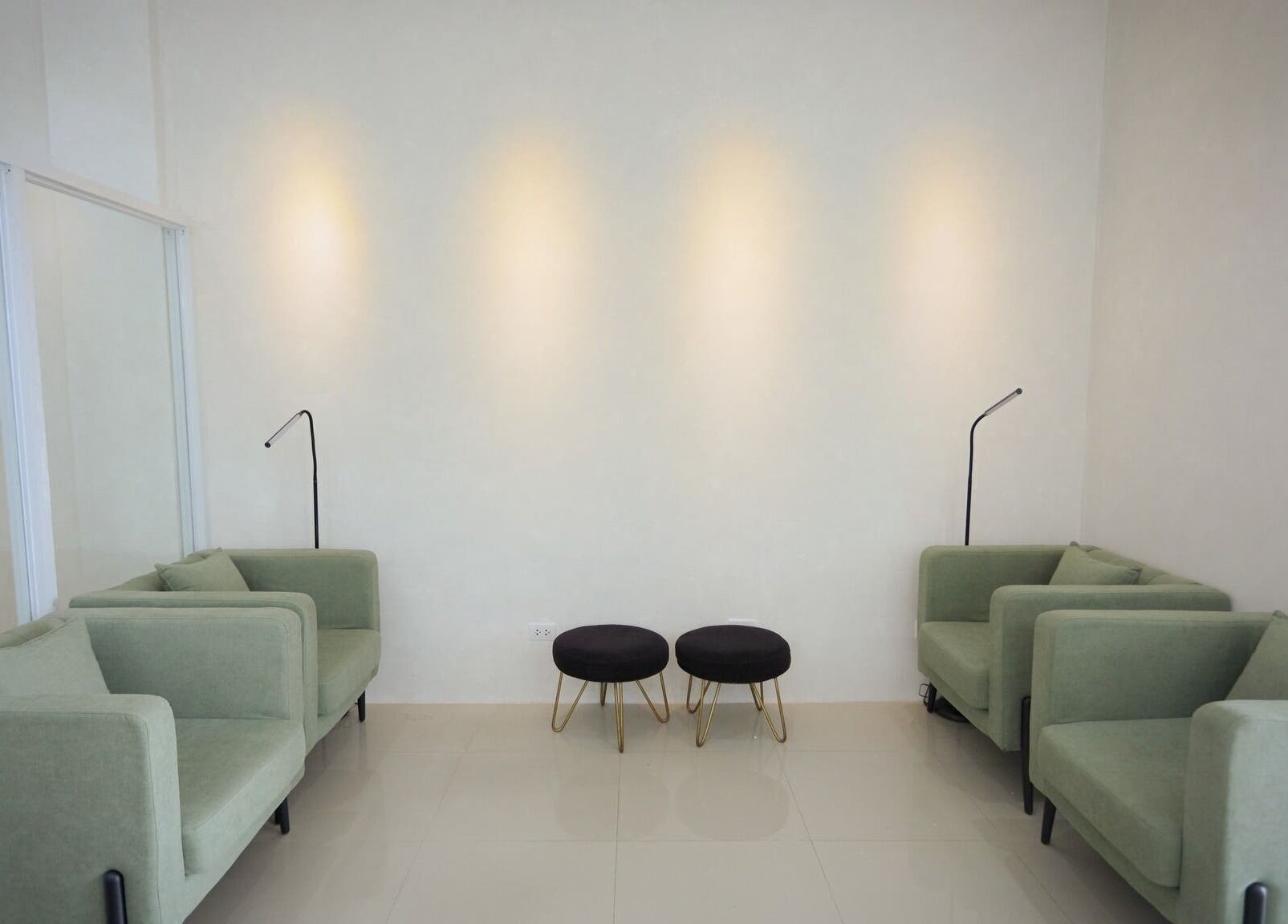 Calm waiting area with green sofas at HelloMello Salon, Angeles, Central Luzon, PH.