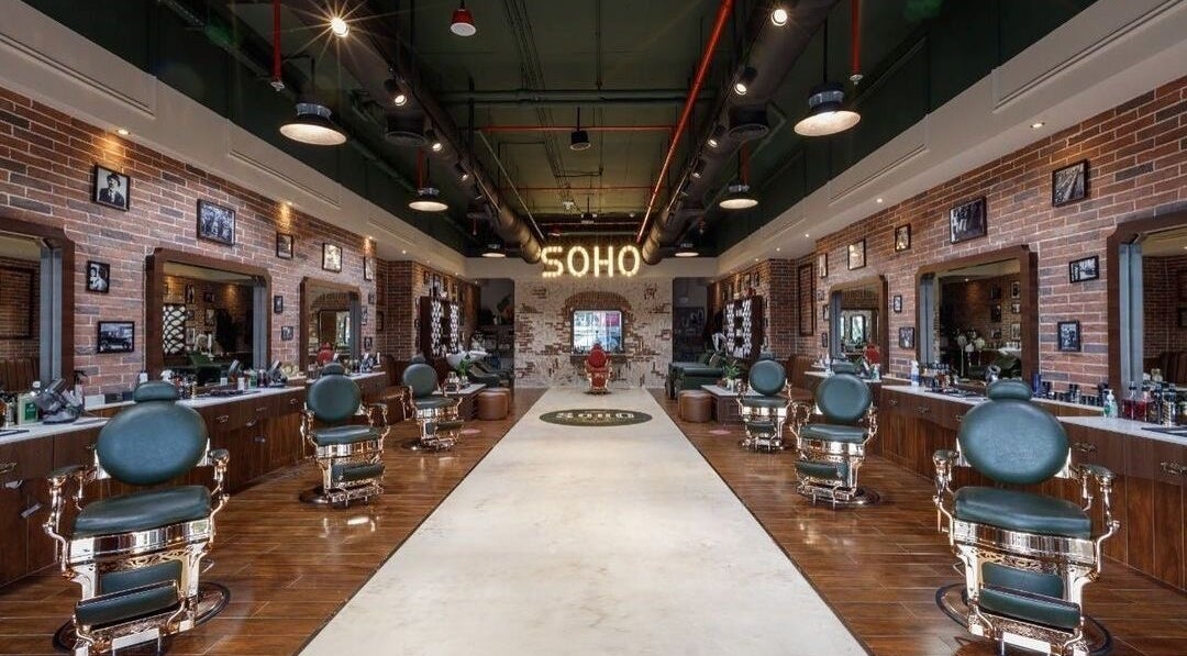 Interior of Soho Vintage Barbers on Sheikh Zayed Road, Dubai. Classic barber chairs and brick decor create a vintage feel.