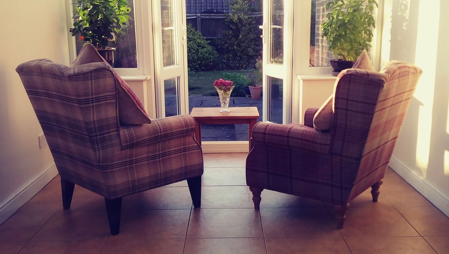 Cozy chairs by the window at Dr Laura Allen's venue in Burbage, England, GB, offering relaxation and views.