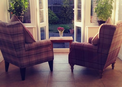 Cozy chairs by the window at Dr Laura Allen's venue in Burbage, England, GB, offering relaxation and views.
