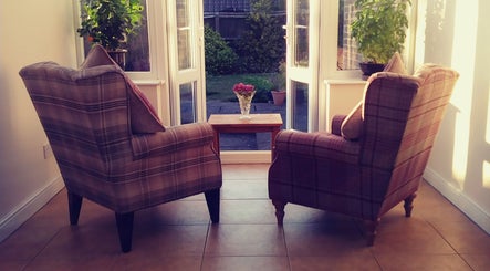 Cozy chairs by the window at Dr Laura Allen's venue in Burbage, England, GB, offering relaxation and views.