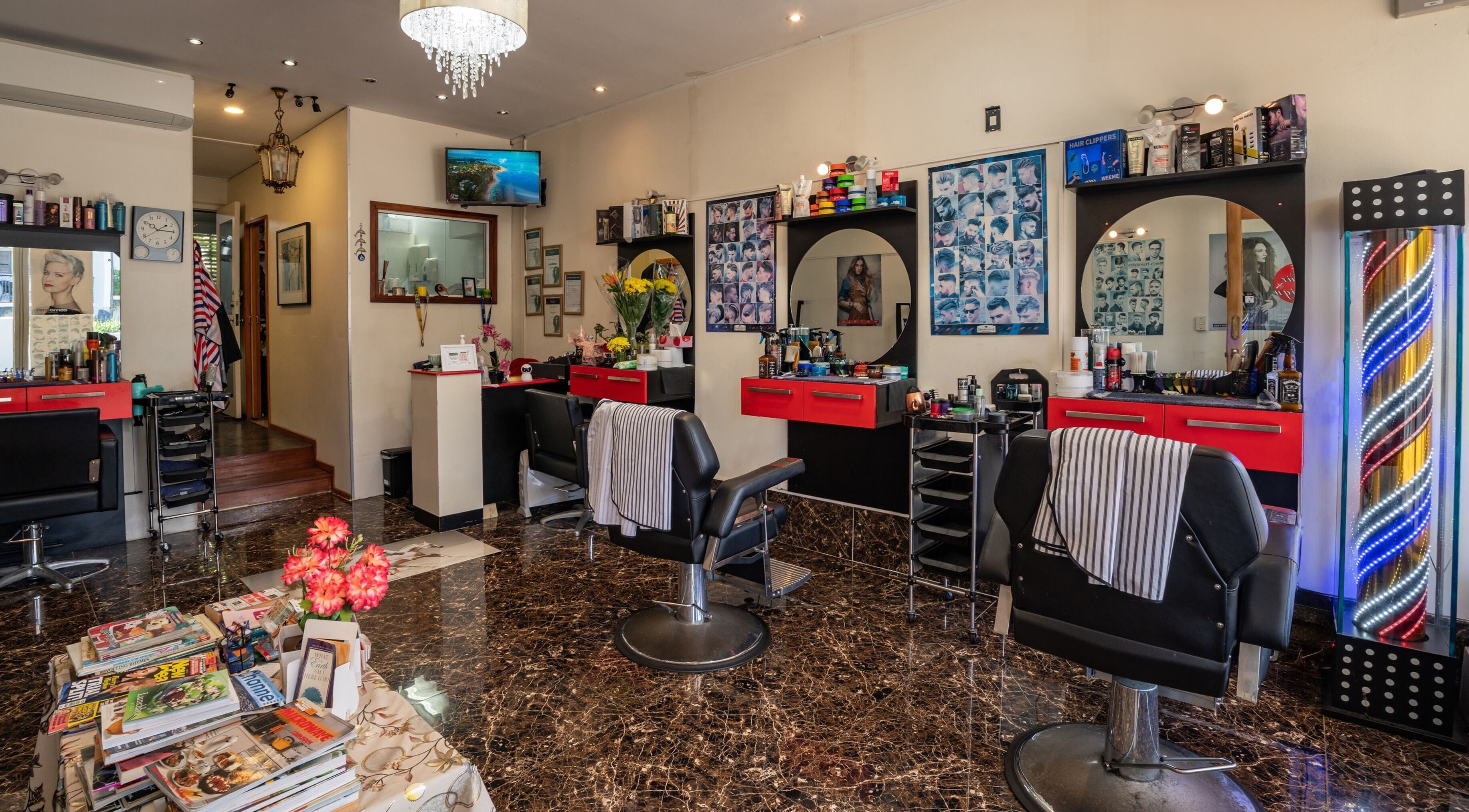 Interior of Takapuna Family Barber and Hairdresser in Auckland, NZ with elegant chairs and stylish décor.