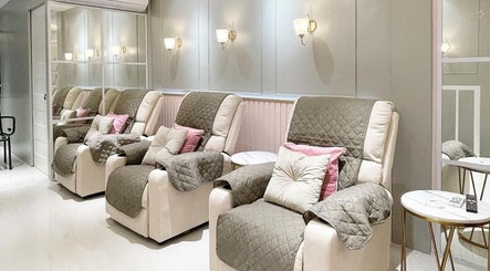 Luxurie Beauty Wellness cozy seating area, Quezon City, Metro Manila, PH, featuring plush chairs and soft lighting.