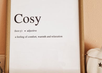 Framed 'Cosy' definition decor at The Hygge Hub in Littleborough, England, GB, enhancing warmth and relaxation.
