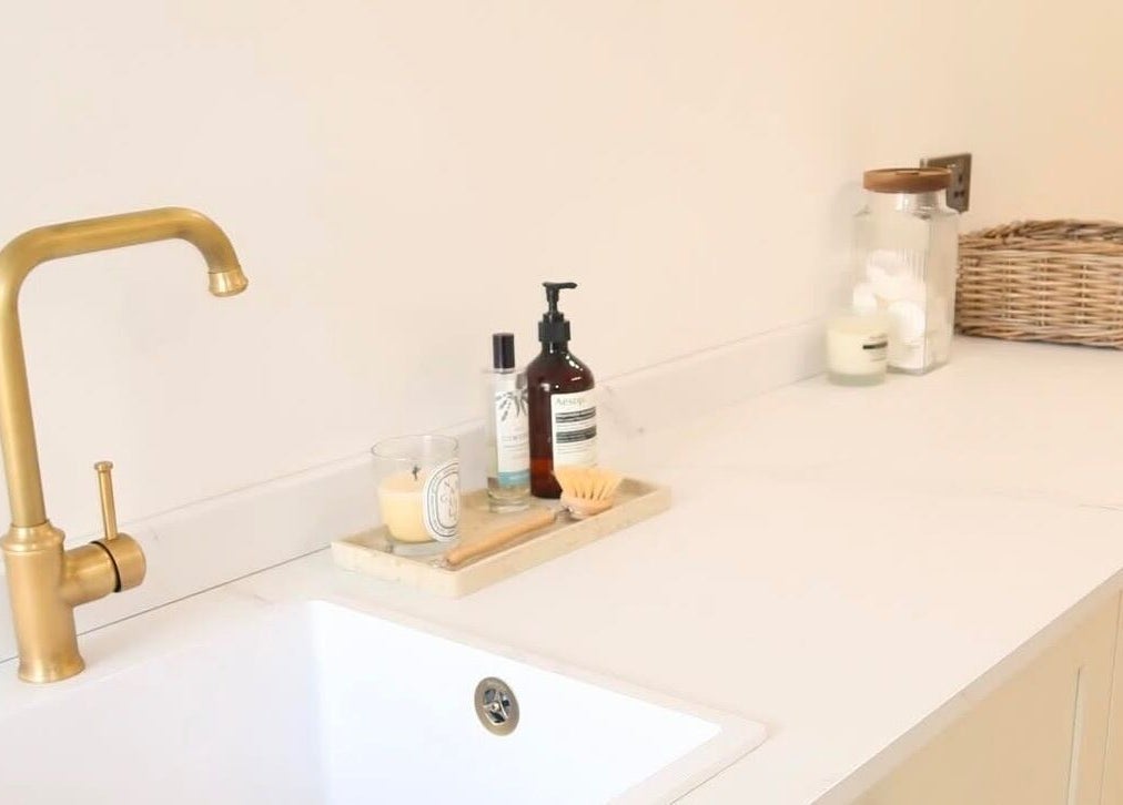 Sophisticated wash area at WESTERHAM, Kent, England, GB with golden faucet and organic toiletries.
