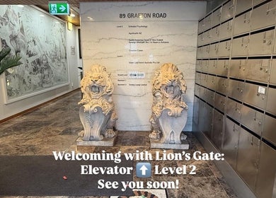 Entrance of Ko Ko Infinite Chiropractic Grafton in Auckland with lion statues and elevators.