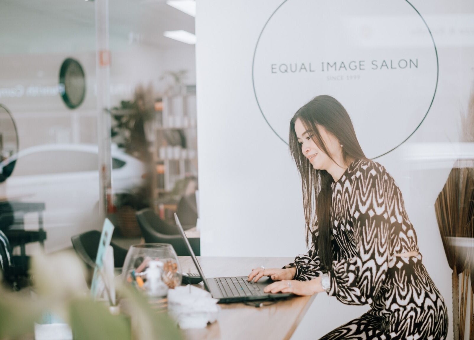 Woman working at a desk in Equal Image Salon, Penrith, New South Wales, AU.