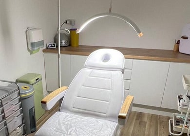 Modern treatment room at Skin South Wales, Trethomas, Wales, GB showcasing a comfortable white therapy chair.