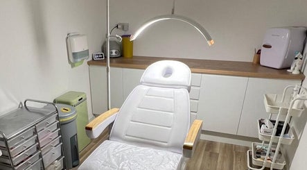 Modern treatment room at Skin South Wales, Trethomas, Wales, GB showcasing a comfortable white therapy chair.