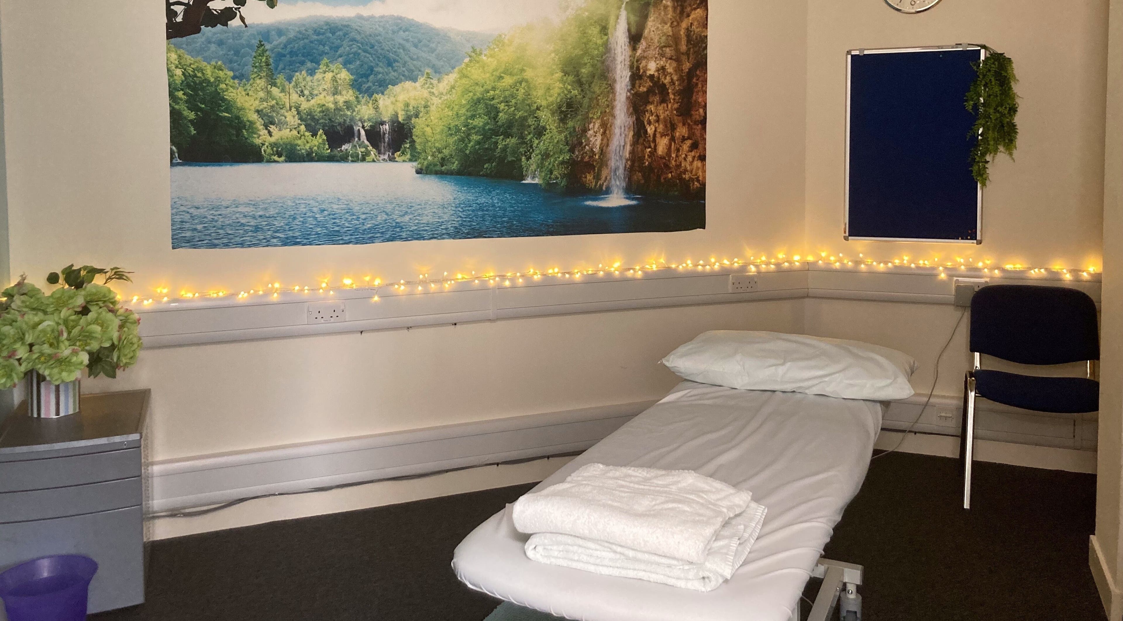 Relaxing treatment room at UCLH Staff Only Spa in London, England, GB, with nature-themed decor and warm lighting.