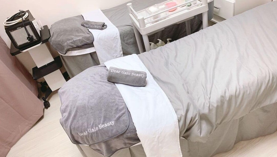 Luxurious treatment beds at Dear Gals Beauty in Hong Kong, HK, offering a serene spa experience.