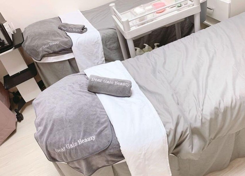 Luxurious treatment beds at Dear Gals Beauty in Hong Kong, HK, offering a serene spa experience.