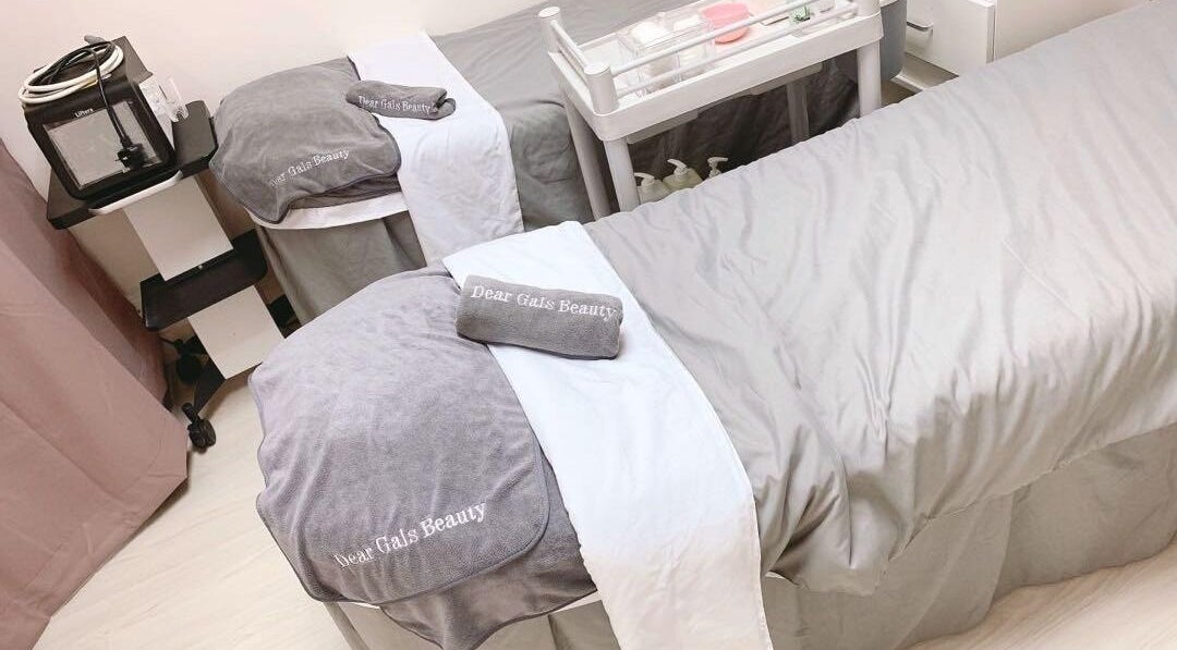 Luxurious treatment beds at Dear Gals Beauty in Hong Kong, HK, offering a serene spa experience.