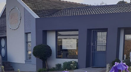 Exterior of XCO MAN, Cape Town, Western Cape, ZA, featuring modern architecture and vibrant garden.