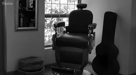 Vintage barber chair at XCO MAN, Cape Town, Western Cape, ZA, near sunlit window and mirror.