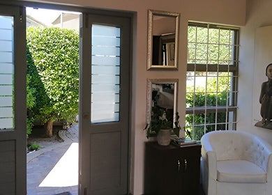 Bright interior at XCO MAN, Cape Town, Western Cape, ZA featuring modern decor and lush garden view.