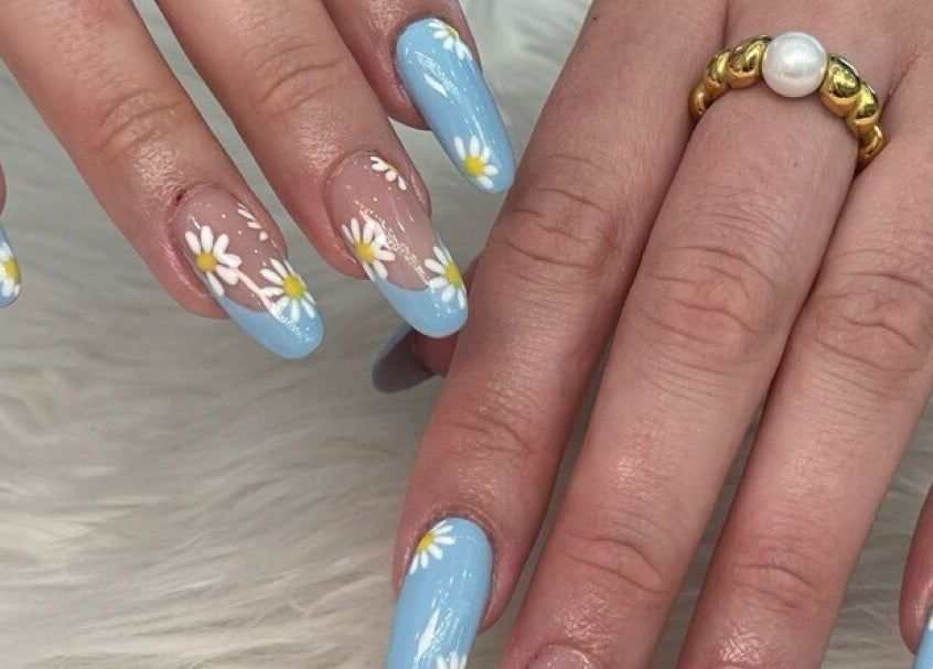 Fresh daisy nail art with blue polish at Ava Nail Bar Geneva, located in Geneva, Illinois, US.