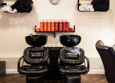 Elegant hair washing station at Escape Hair, Strensall, England, GB with plush chairs and premium products.