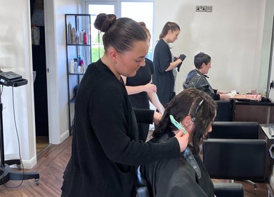 Stylists working on clients at Escape Hair in Strensall, England, GB, creating chic and trendy hairstyles.