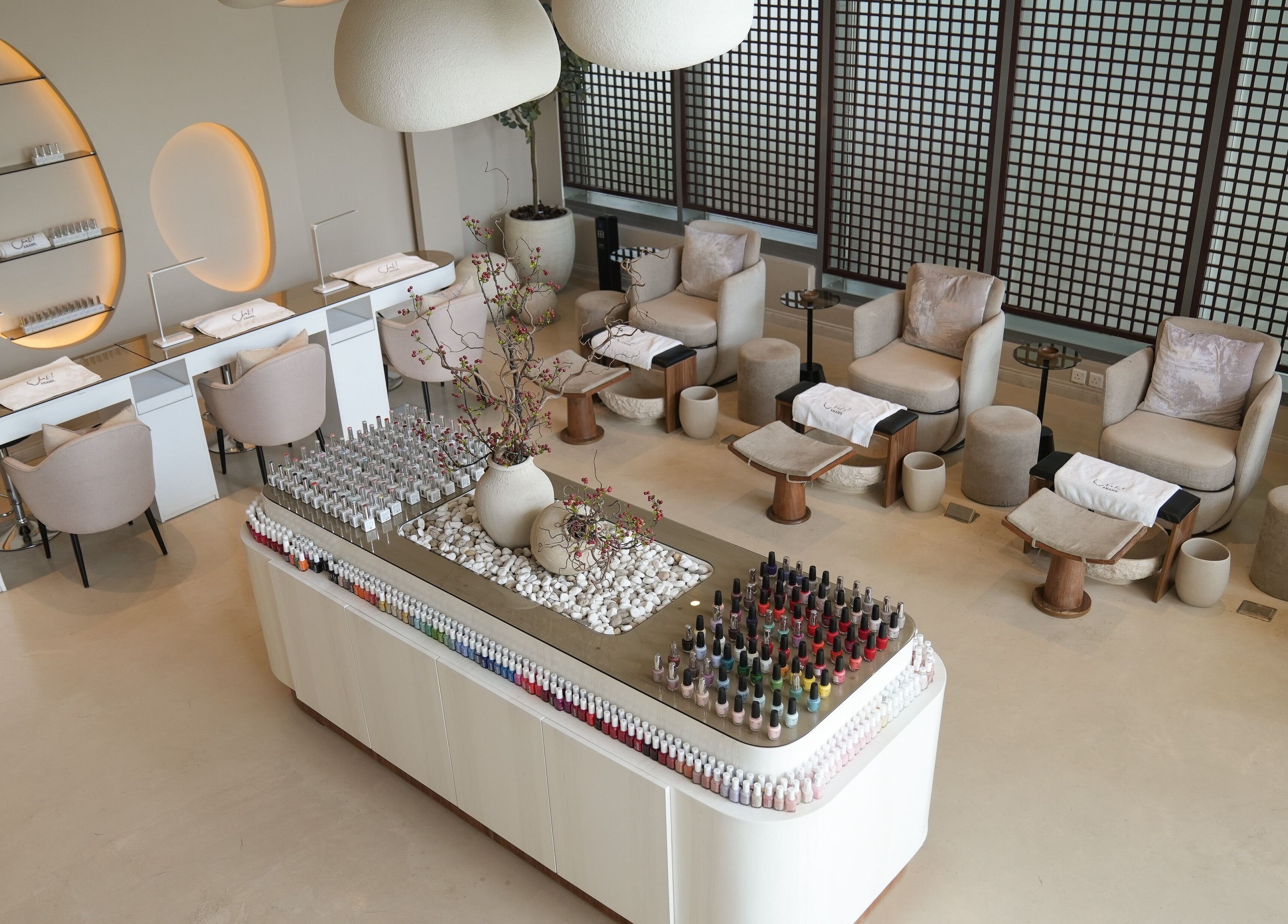 Elegant nail salon interior at Anamil Spa - Qurtubah, Riyadh. Modern design with spa chairs and nail polish display.