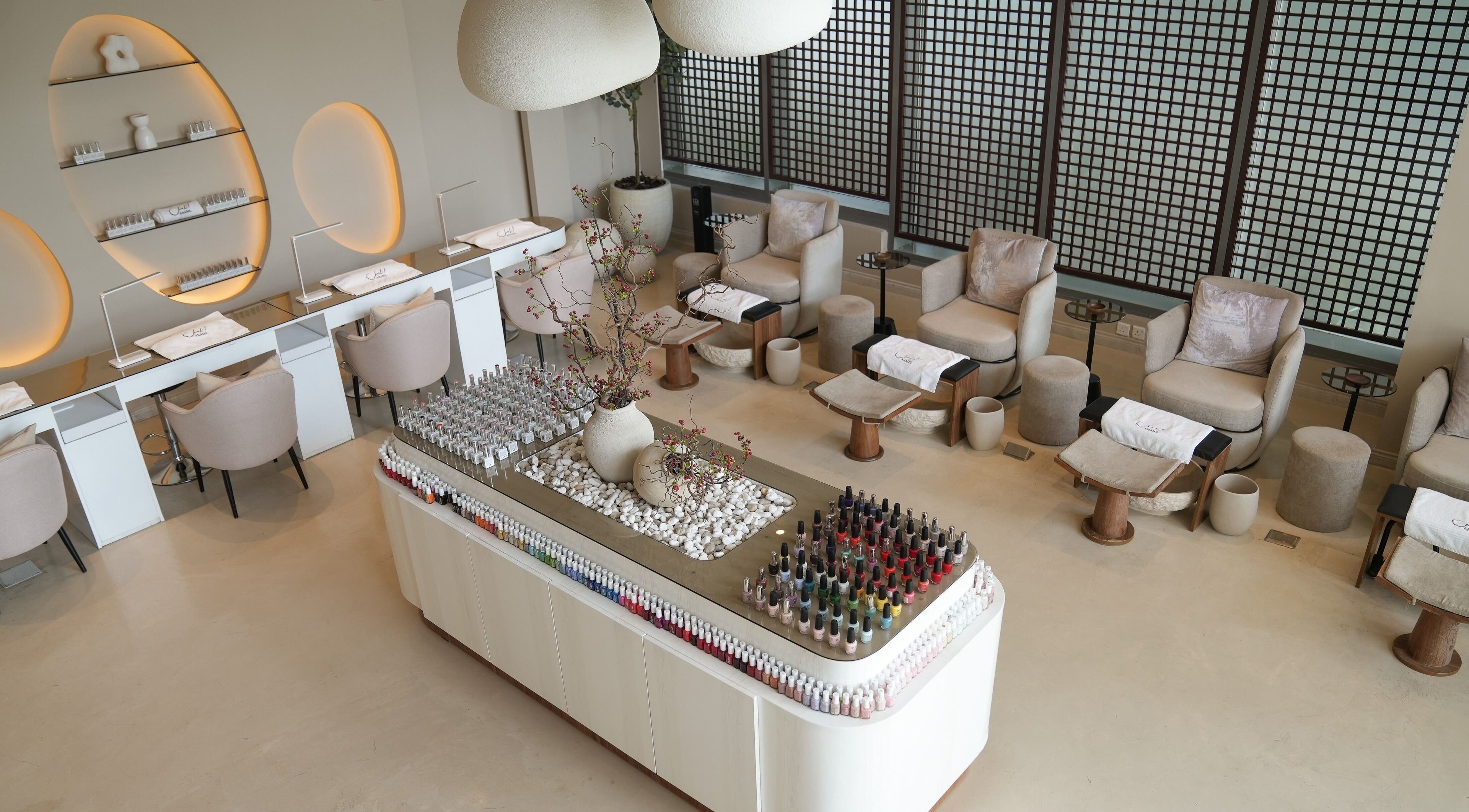 Elegant nail salon interior at Anamil Spa - Qurtubah, Riyadh. Modern design with spa chairs and nail polish display.