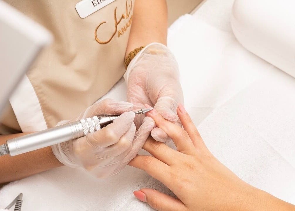 Nail technician providing nail care at Anamil Spa - Qurtubah, Riyadh, Riyadh Province, SA. Experience precision.