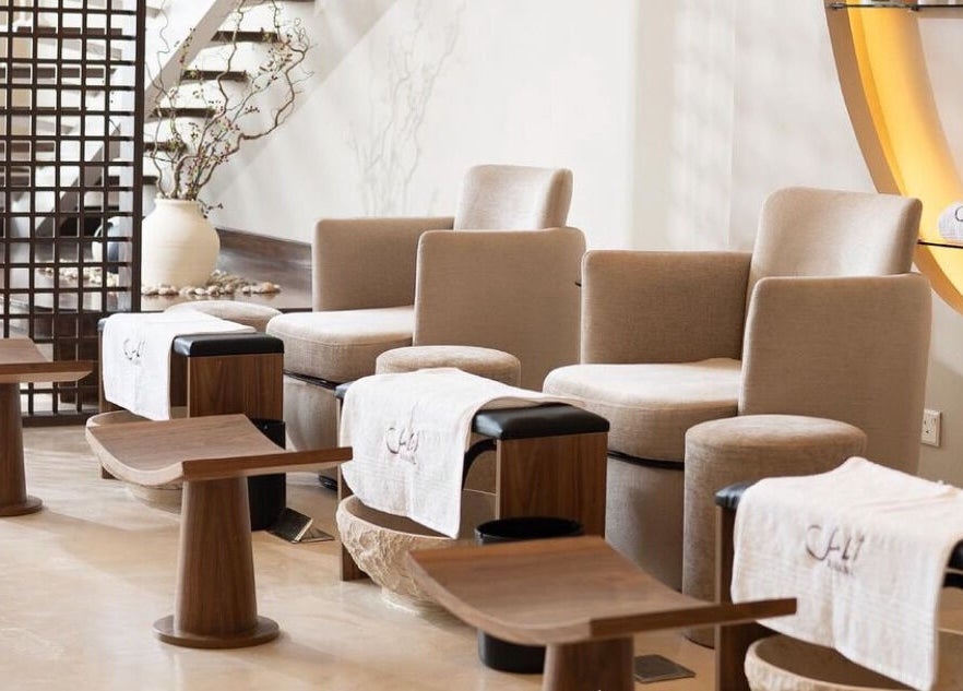 Relaxing seating area at Anamil Spa - Qurtubah, Riyadh, with plush chairs and footrests in a tranquil setting.