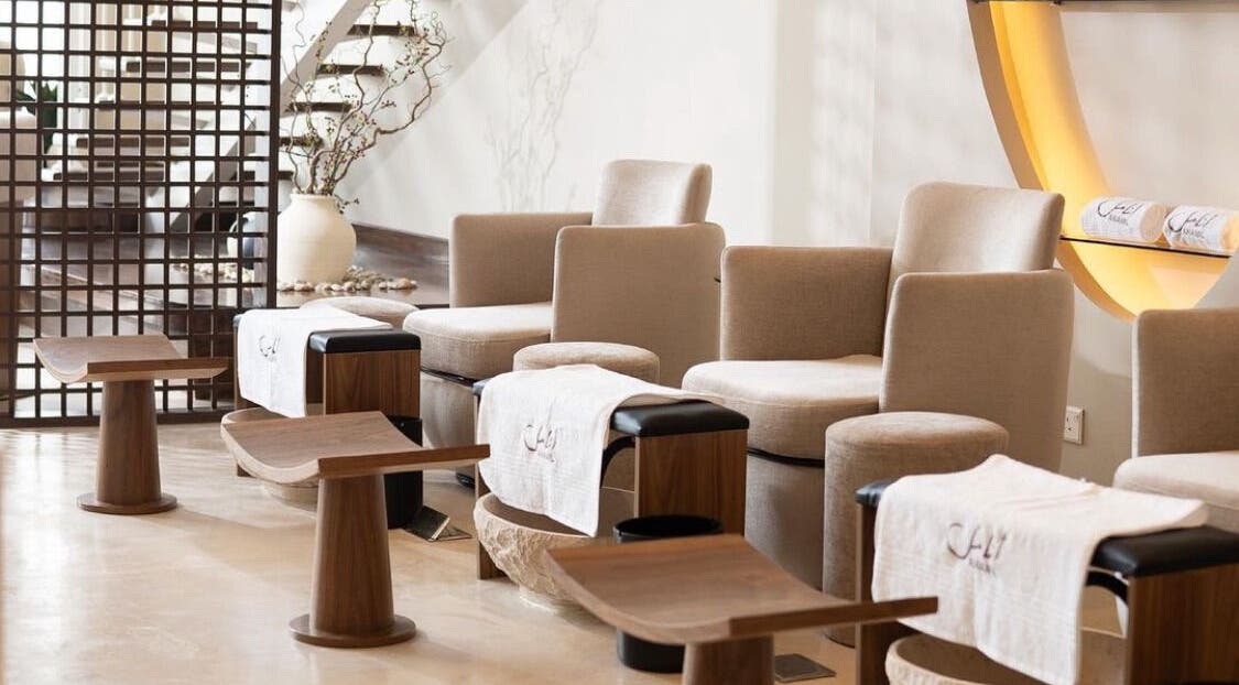 Relaxing seating area at Anamil Spa - Qurtubah, Riyadh, with plush chairs and footrests in a tranquil setting.