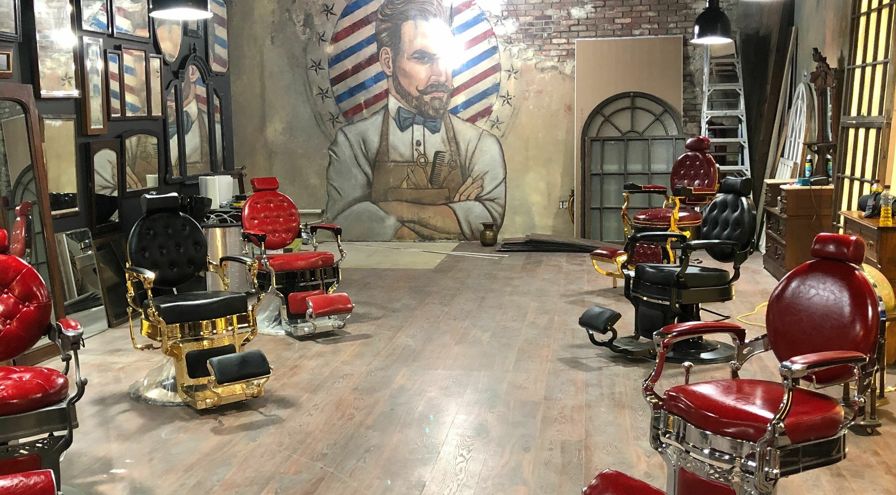 Elegant barber chairs at Vosco’s Barbershop, Logan, Utah, US with a classic mural backdrop.