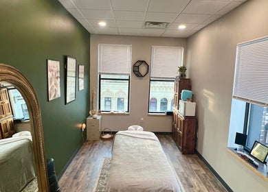 Calm massage room at Body Alchemy Massage LLC, Fond Du Lac, Wisconsin, US offers a peaceful ambiance with city views.