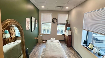 Calm massage room at Body Alchemy Massage LLC, Fond Du Lac, Wisconsin, US offers a peaceful ambiance with city views.