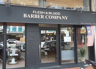 Front view of Flesh & Blood Barber Company in Kuantan, Pahang, MY, showcasing stylish entrance and signage.