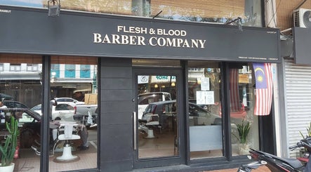 Front view of Flesh & Blood Barber Company in Kuantan, Pahang, MY, showcasing stylish entrance and signage.