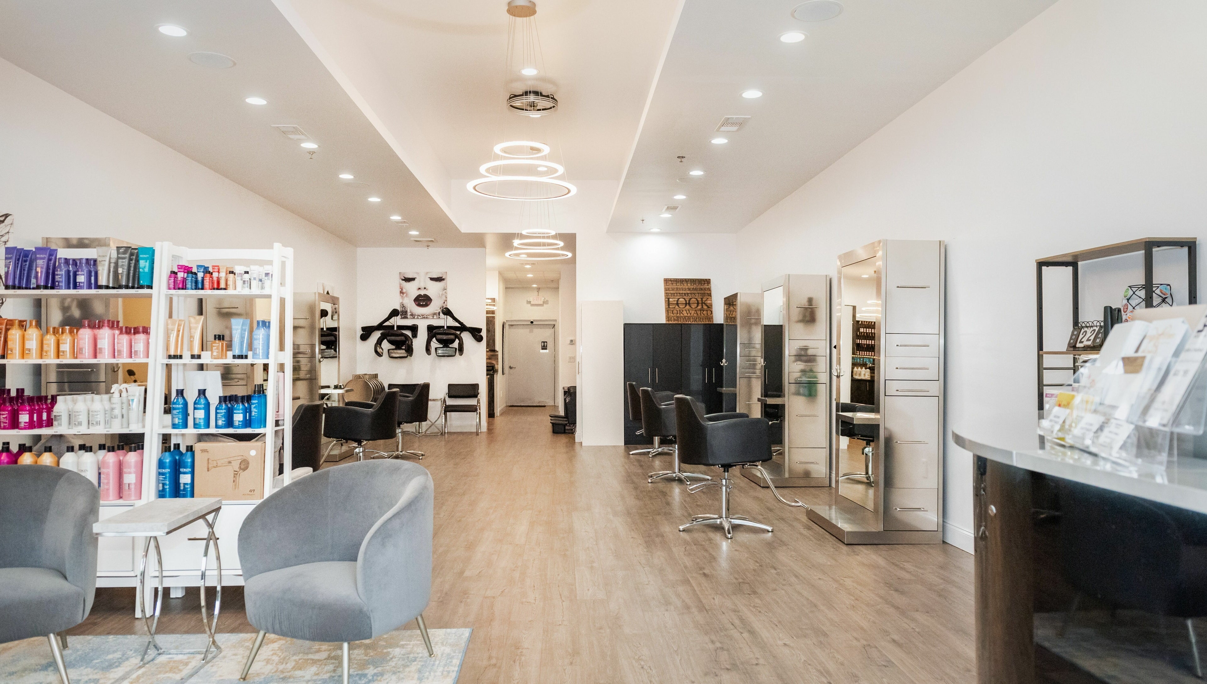 Modern interior of Moochini Hair Salon, Alpharetta, Georgia, US, with sleek furnishings and vibrant products.