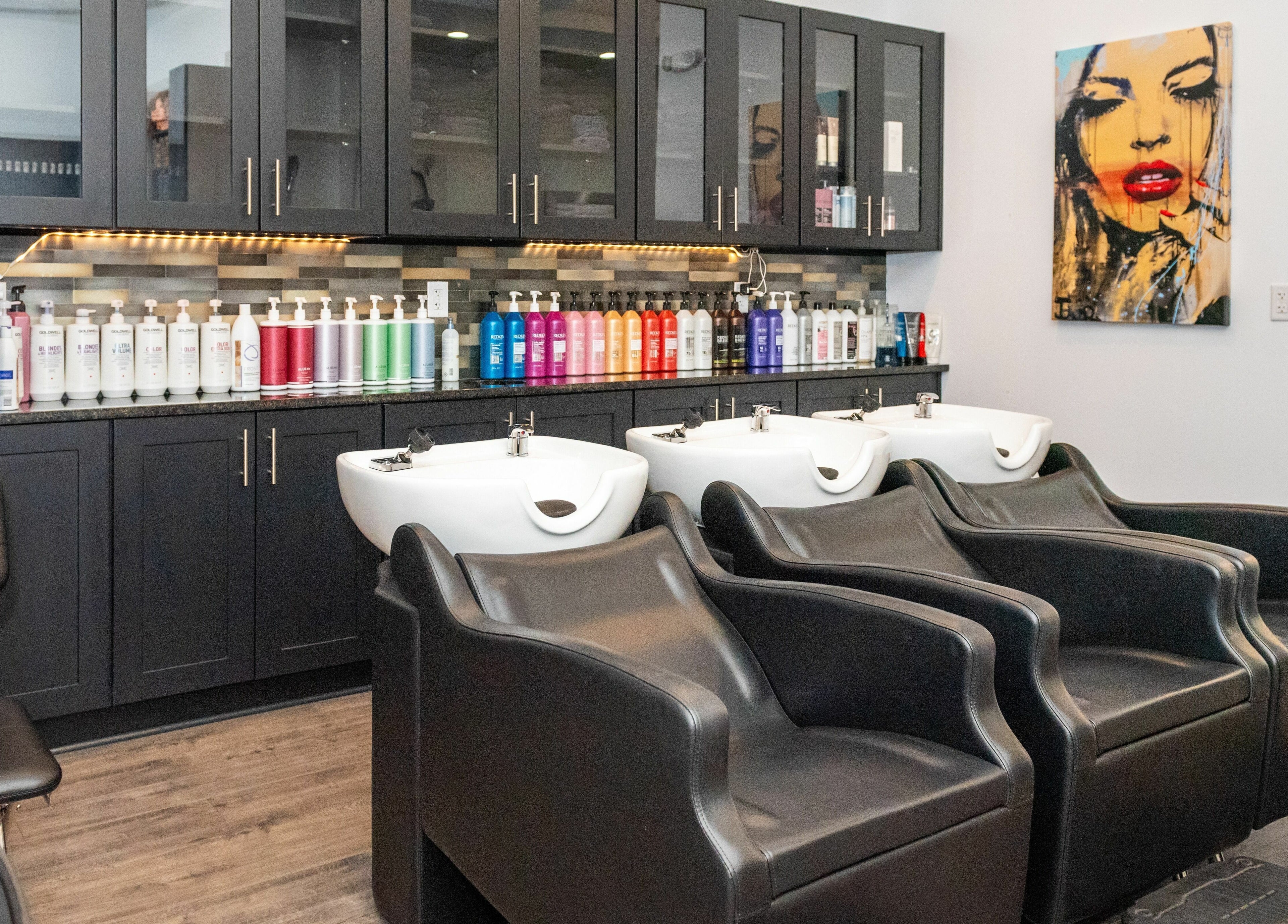 Moochini Hair Salon in Alpharetta, Georgia, US features stylish hair washing stations and vibrant product display.