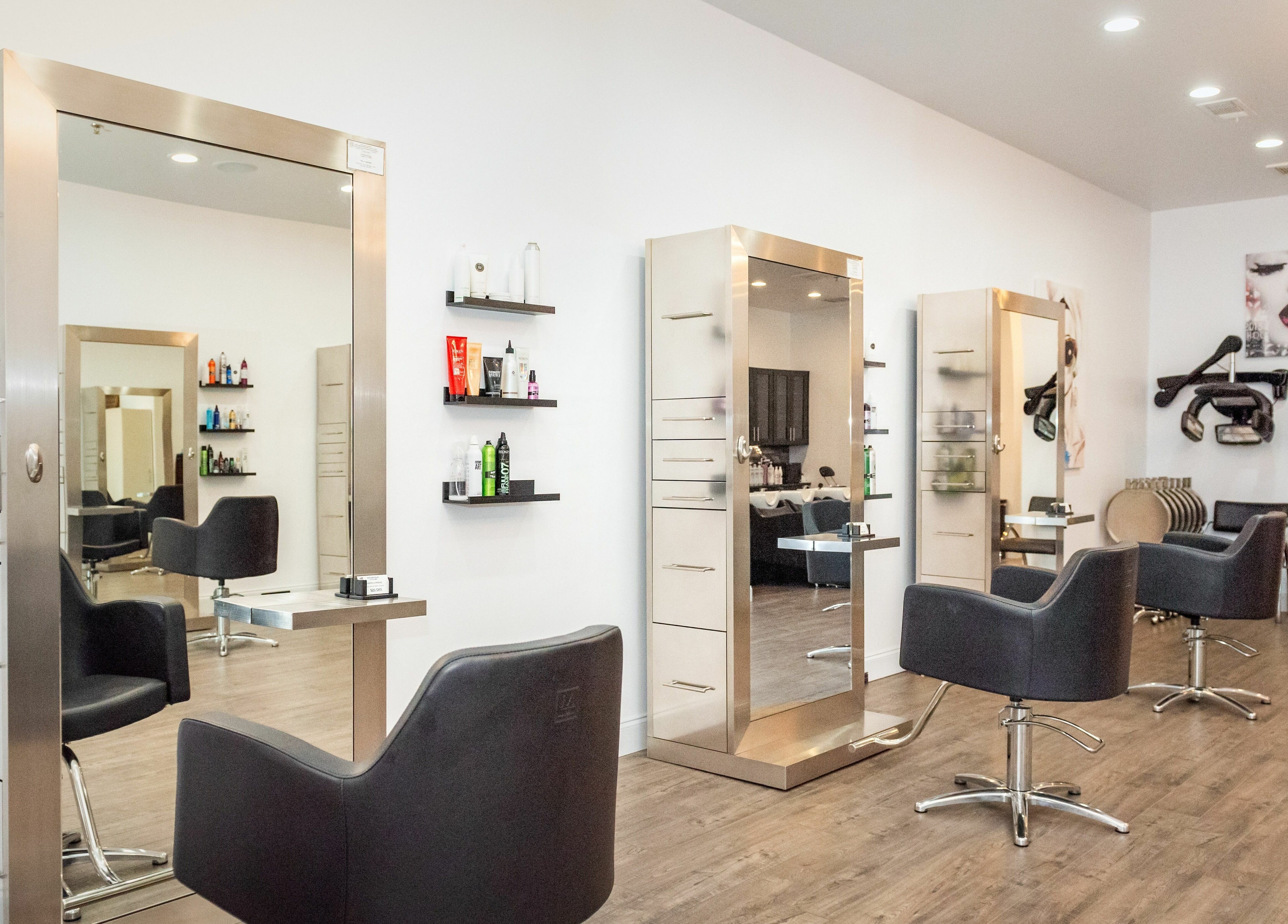 Elegant interior of Moochini Hair Salon in Alpharetta, Georgia, US, featuring sleek styling stations.