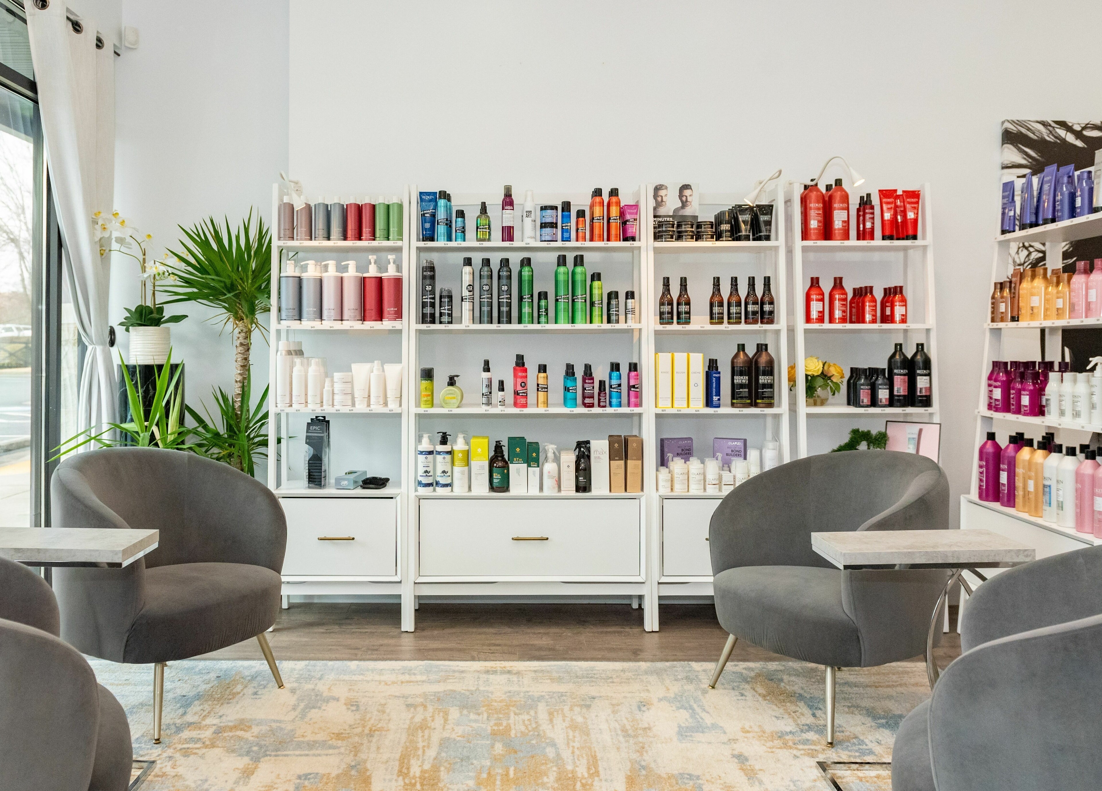 Moochini Hair Salon's chic interior with product-filled shelves in Alpharetta, Georgia, US.