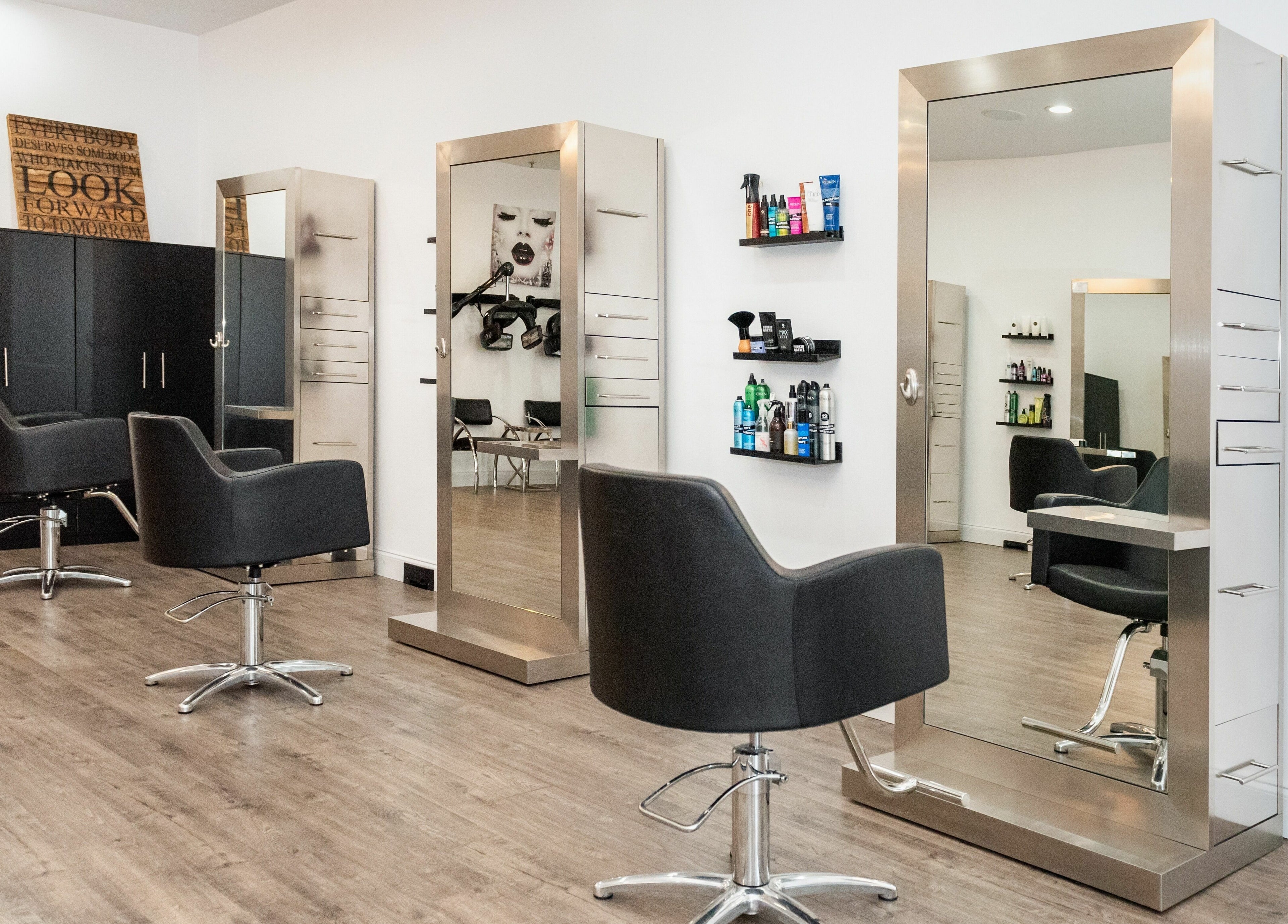 Modern salon interior at Moochini Hair Salon in Alpharetta, Georgia, US featuring sleek chairs and mirrors.