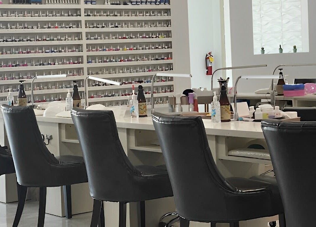 Modern nail stations inside Skye Nail Lounge, Las Vegas, Nevada, US, showcasing rows of polish and sleek seating.