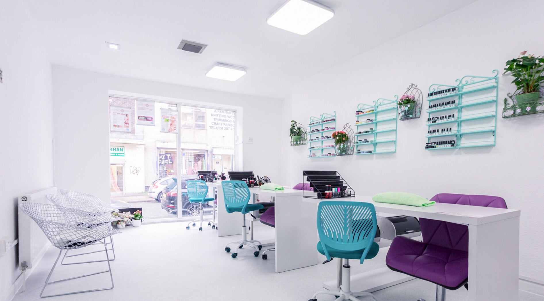 Bright nail salon interior at Lilly Nail & Beauty Liverpool, Liverpool, England, GB. Modern decor and vibrant chairs.