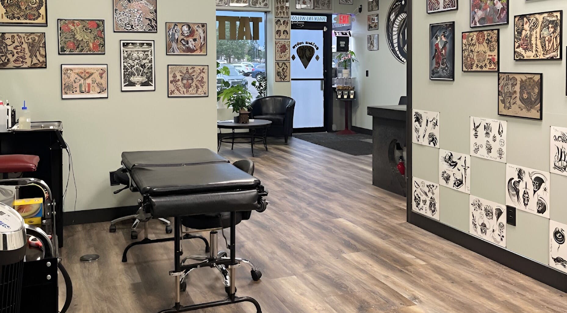 Interior of Golden Cobra Tattoo and Piercing, Fridley, Minnesota, US, showcasing tattoo art and seating.