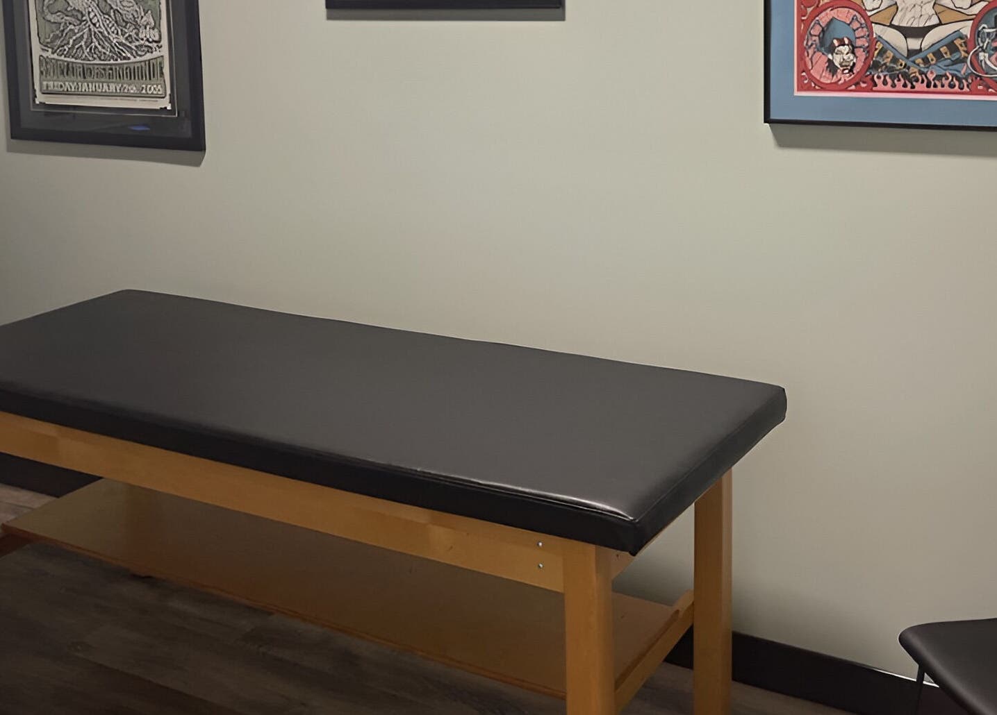 Tattoo room at Golden Cobra Tattoo and Piercing, Fridley, Minnesota, US, featuring a black cushioned table.