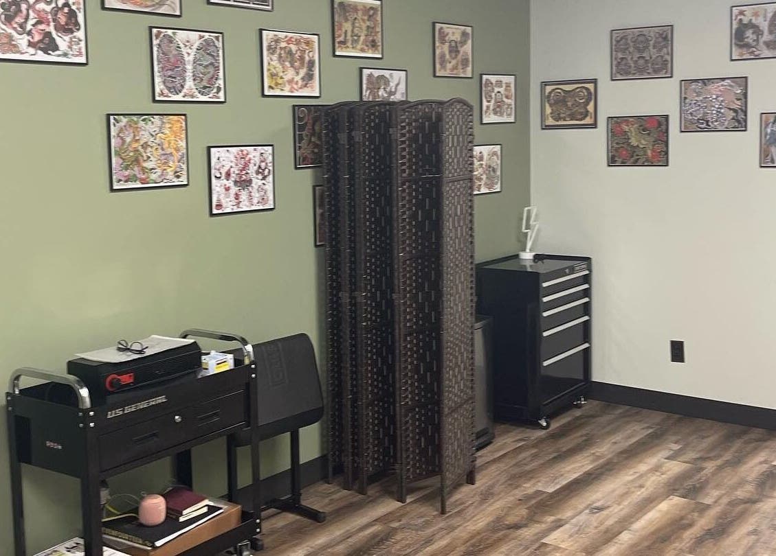 Interior wall of Golden Cobra Tattoo and Piercing in Fridley, Minnesota, US showcasing tattoo art decor.