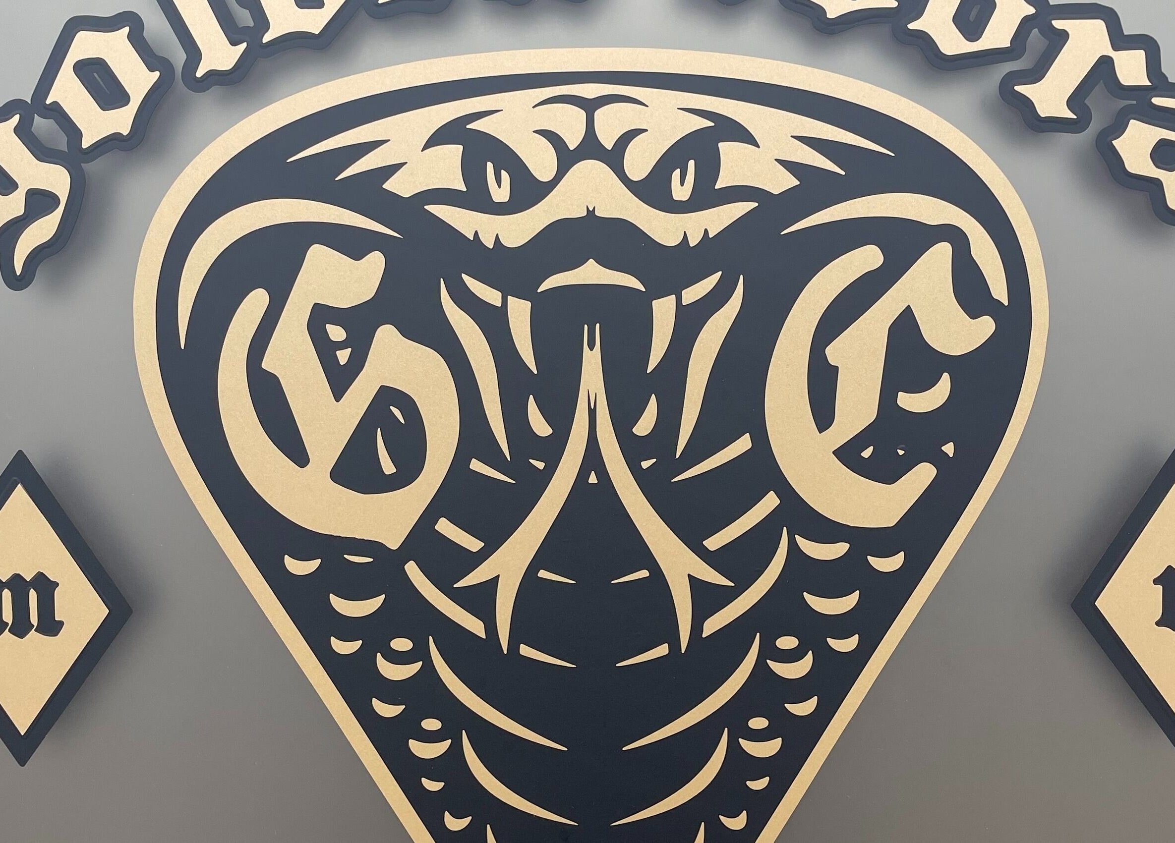 Golden Cobra Tattoo and Piercing sign, showcasing bold cobra emblem, Fridley, Minnesota, US.