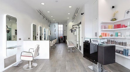 Chic interior of Naya Hair & Beauty in London, England, GB featuring sleek styling stations and bright decor.
