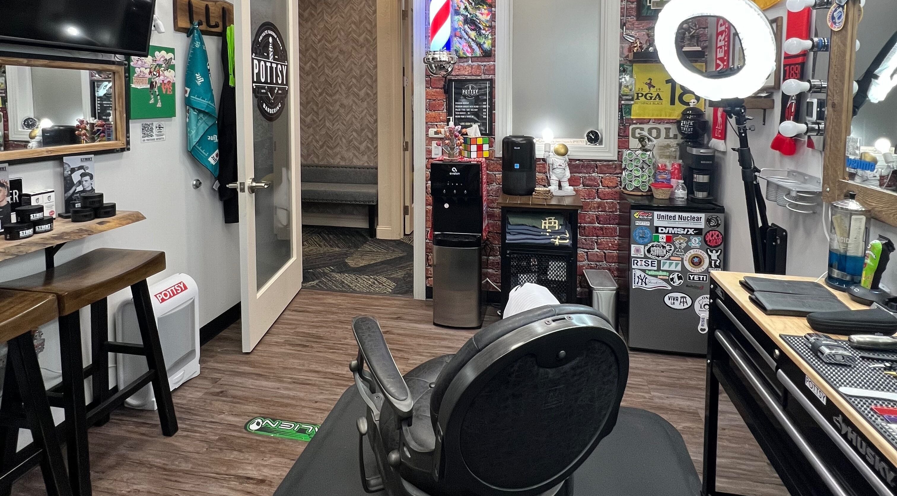 Modern interior of Pottsy Barber Suite in Cinnaminson, New Jersey, US showcasing a stylish barber chair and decor.