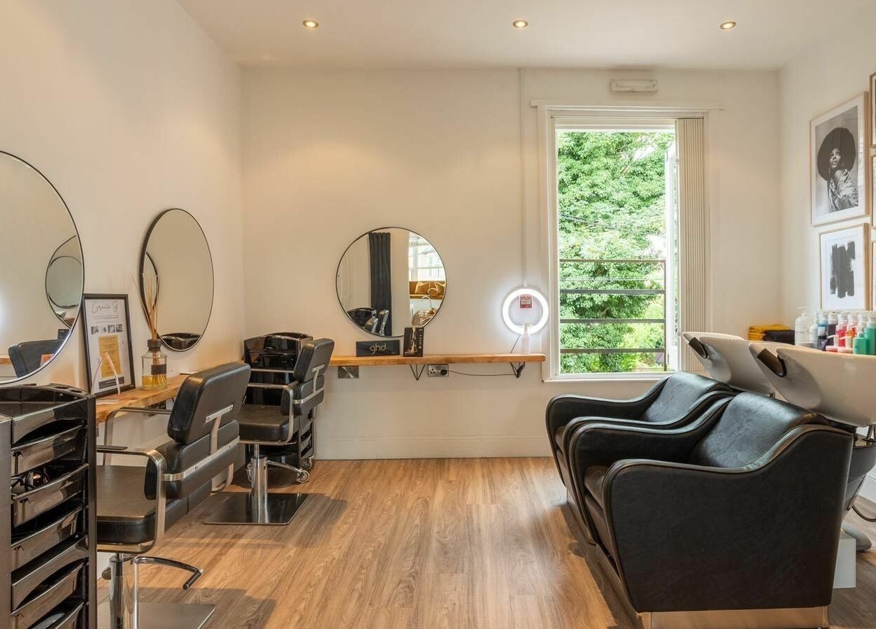 Modern salon interior at Gracie B Ltd, West Bridgford, England, GB with stylish mirrors and seating.