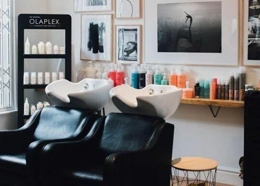 Stylish hair wash area at Gracie B Ltd, West Bridgford, England, GB with Olaplex products on display.