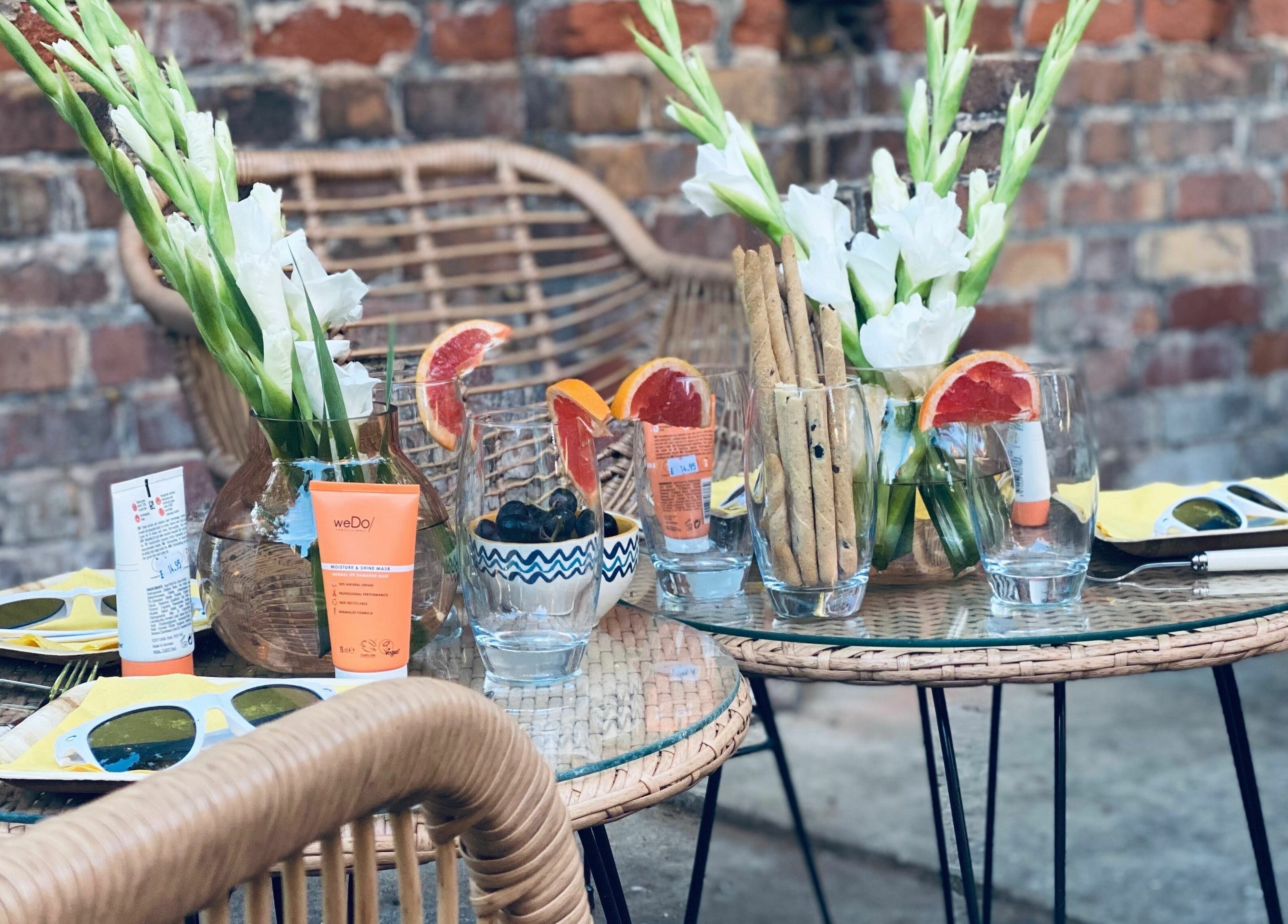 Outdoor seating with drinks and flowers at Gracie B Ltd, West Bridgford, England, GB.