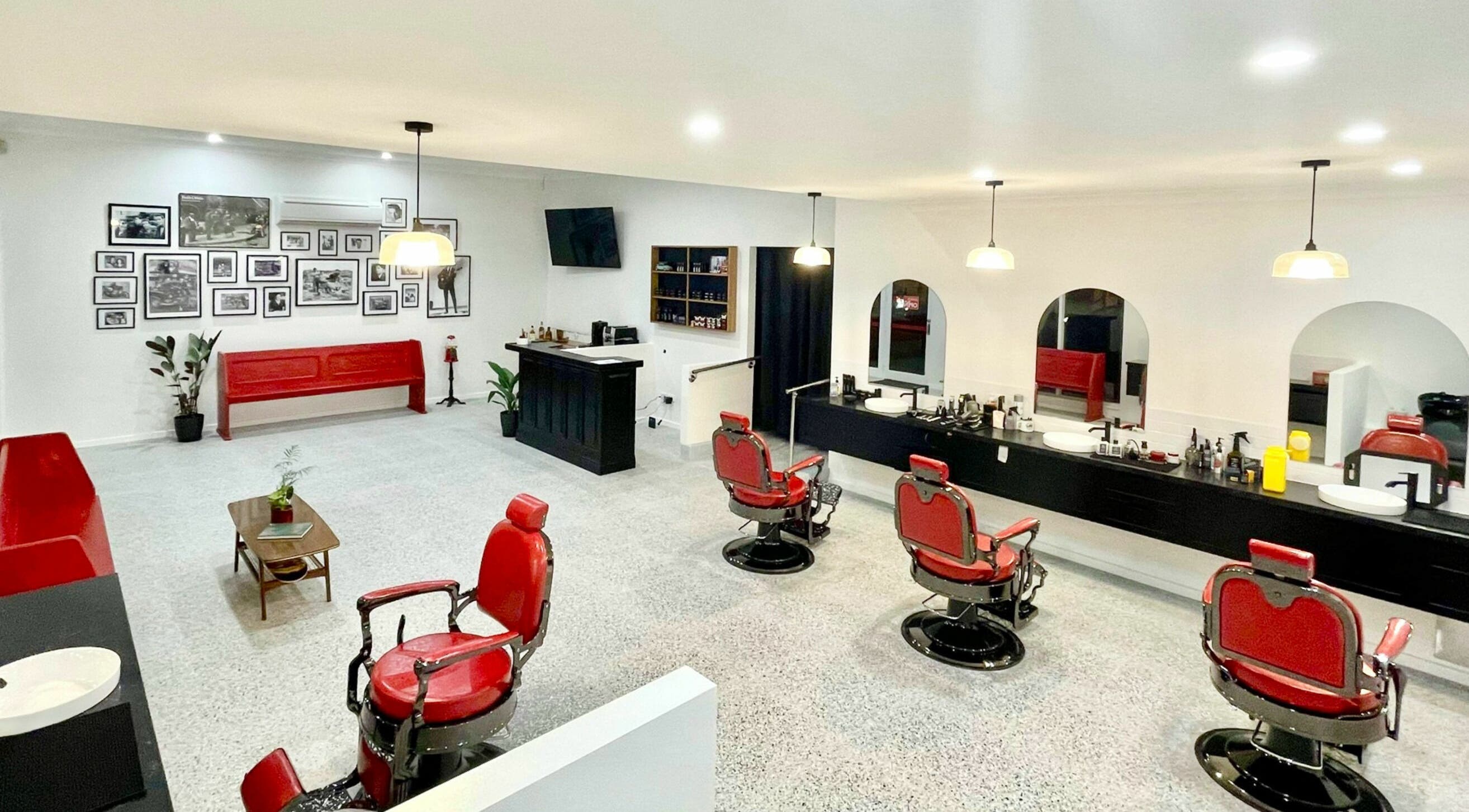 Classic interior of San Antonio Barbershop, Melbourne, Victoria, AU with vintage red chairs and stylish decor.